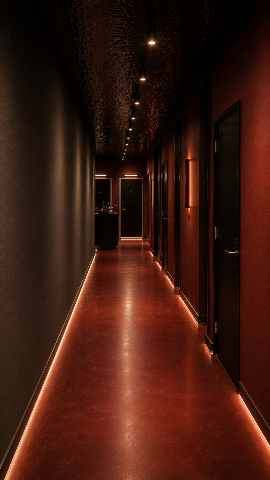 The warm red-lit corridor leading to the private rooms