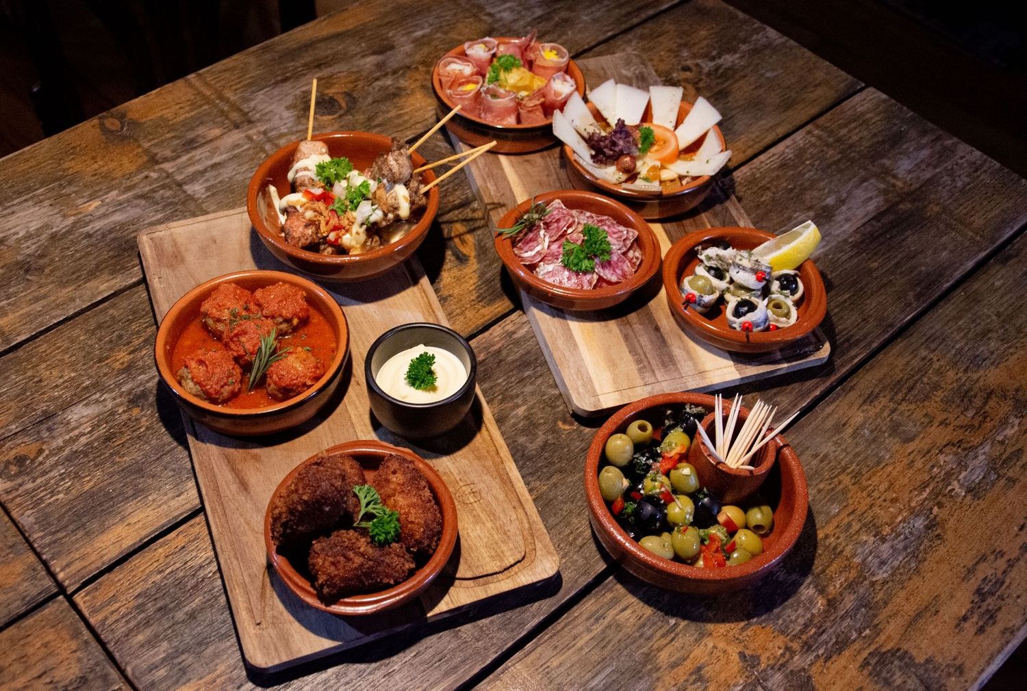 Share plates, fries and drinks on a table at Bibi